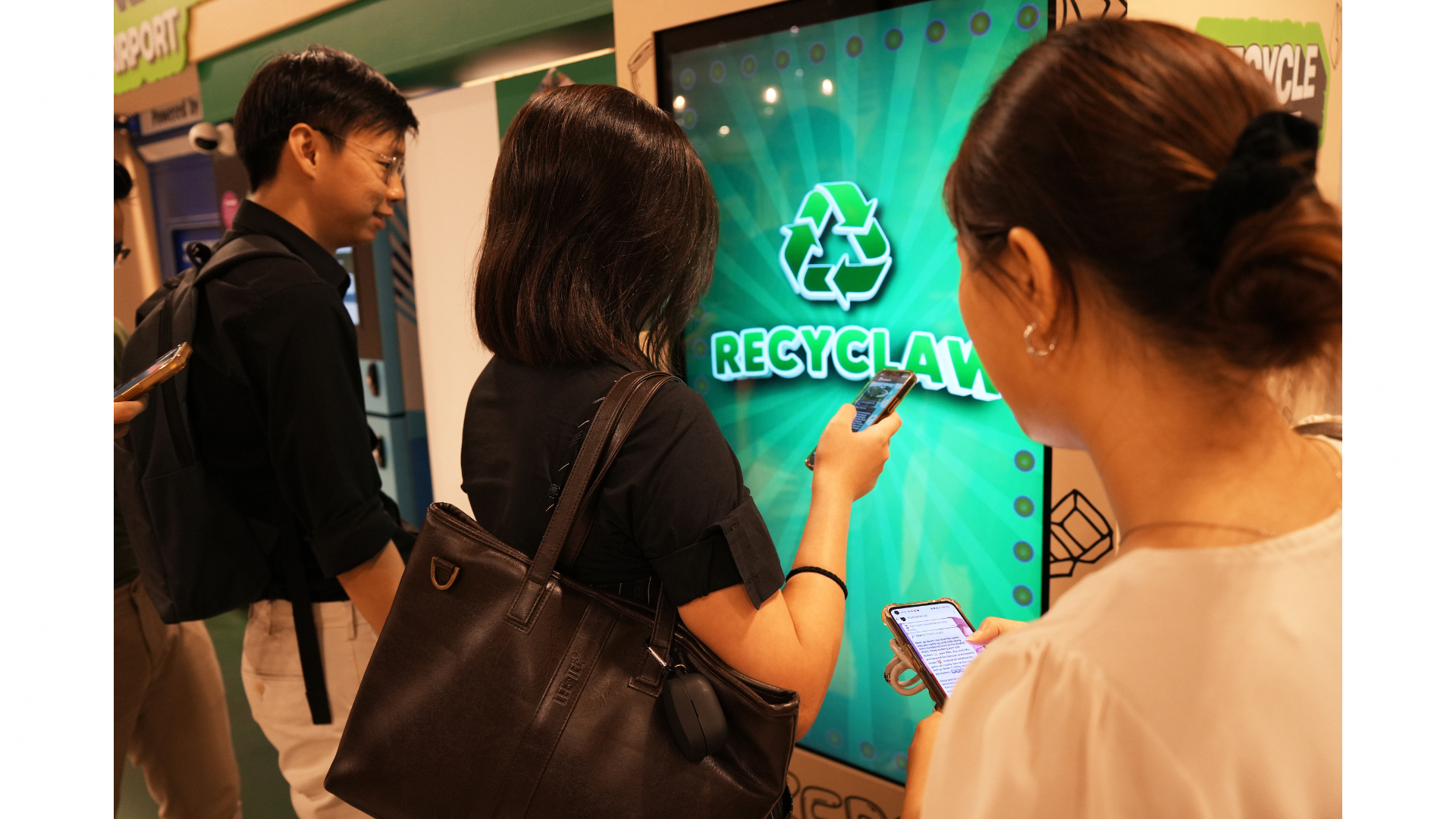 Participants in front of the Recyclaw interactive digital panel