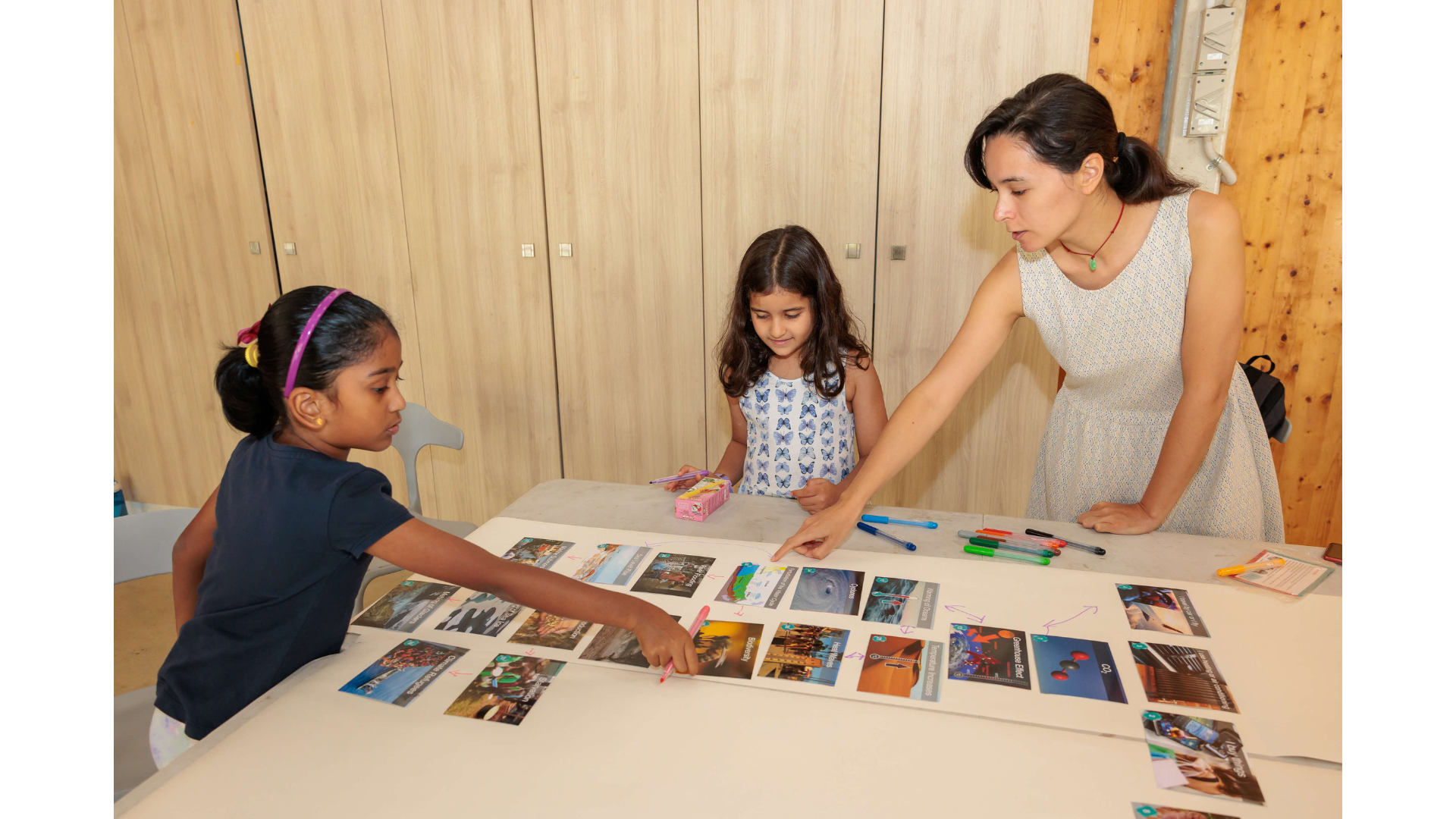 2 girls trying card game designed for younger children