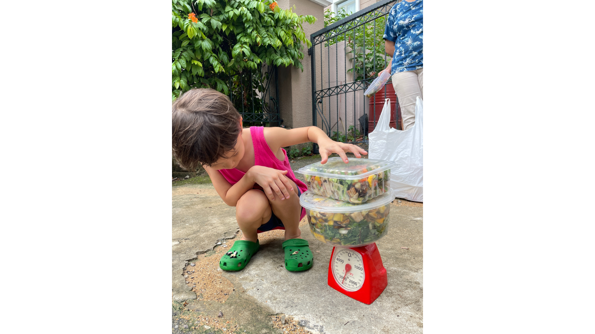 Child weighing food waste