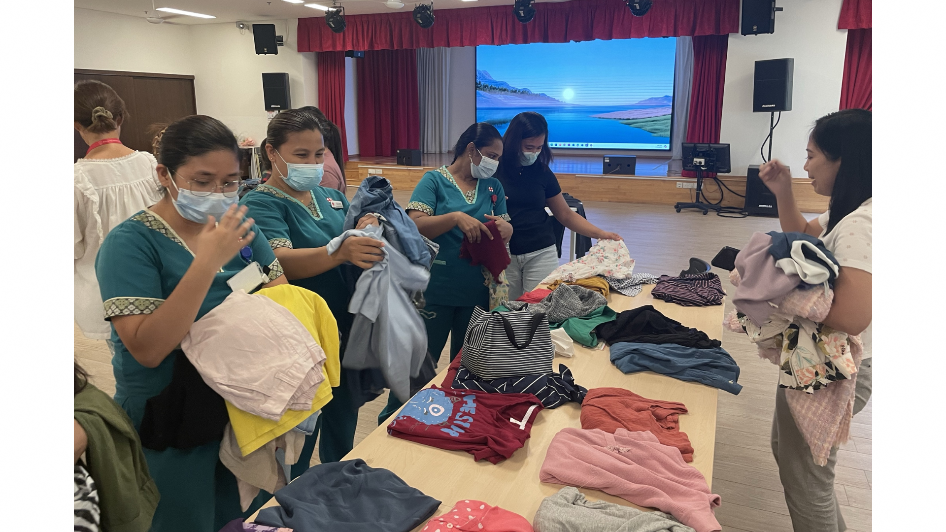 KWSH staff looking through the clothes to swap