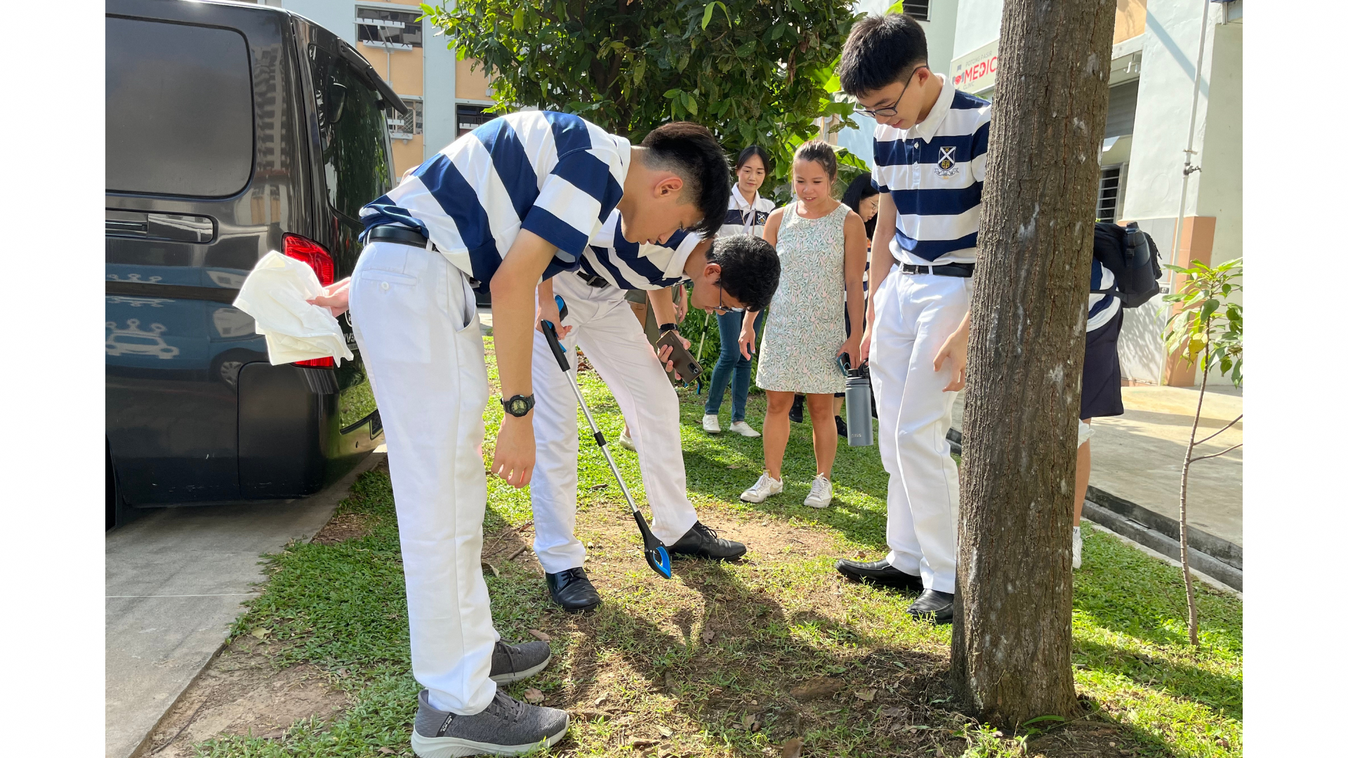 students observing the litter compacted within the grass