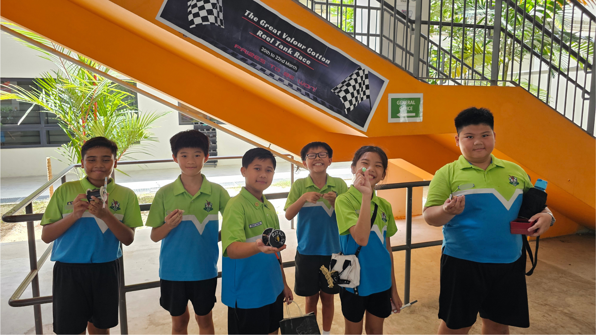 Students holding their cotton reel tanks prototypes